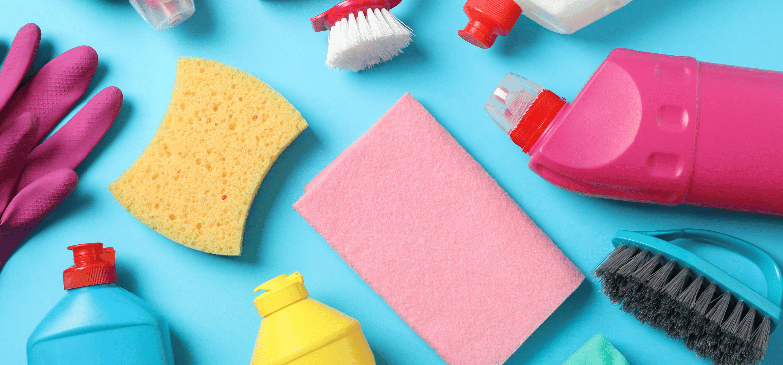 Colourful and quality cleaning supplies laid out on a blue background.
