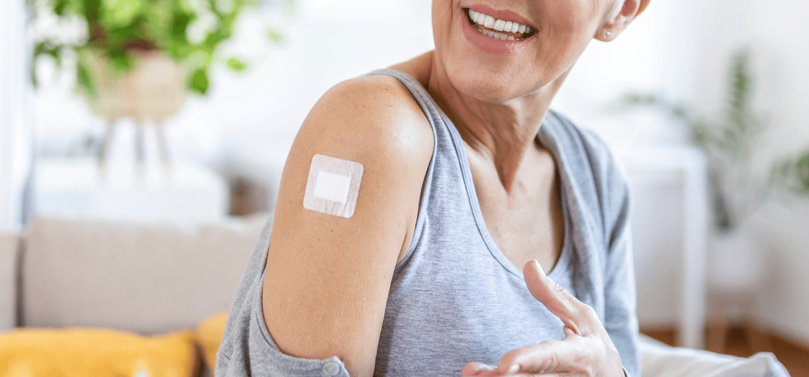 Older women with a Nema Adhesive Island Dress on her wound on her shoulder.