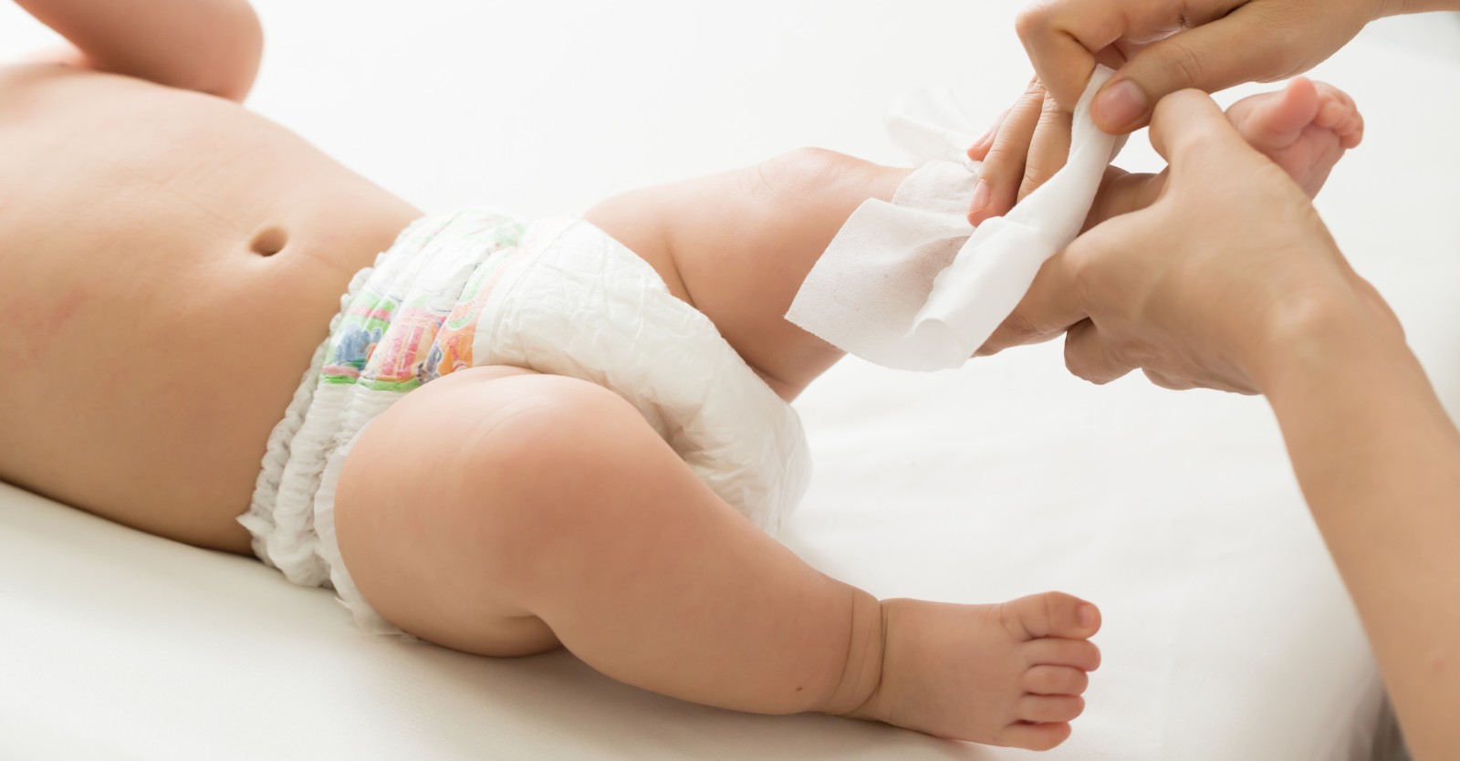 A mother wiping her baby using Organic Baby Wipes